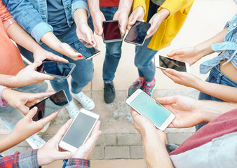 Group of friends using their smart mobile phones - Millennial young people addicted to new...