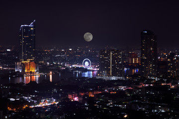 Fototapeta na wymiar night cityscape with full moon and river