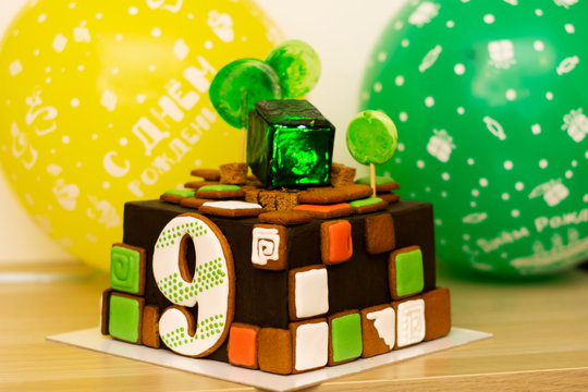 sweet, delicious bright birthday cake for 9 years, backlit in a cube of sweet green ice