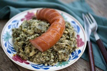 Rustic cuisine with “Boerenkool spamppot” or smoked sausage cabbage, traditional Dutch food. With a typical Dutch plate. stamppot boerenkool .