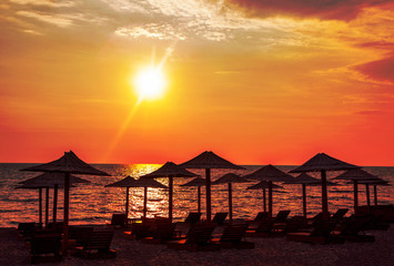 Fototapeta na wymiar tropical island with beach umbrellas in the twilight