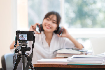 Happy Asian woman videoblog / blogger vlogger recording online course or tutorial coach...