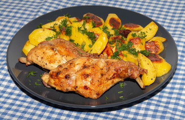 ham rabbit with potatoes cooked in the oven lies on a plate