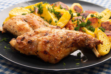 ham rabbit with potatoes cooked in the oven lying on a plate closeup