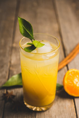 Fresh cocktail with mandarines on the rustic background. Selective focus. Shallow depth of field.