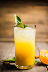 Fresh cocktail with mandarines on the rustic background. Selective focus. Shallow depth of field.