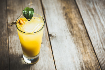 Fresh cocktail with mandarines on the rustic background. Selective focus. Shallow depth of field.