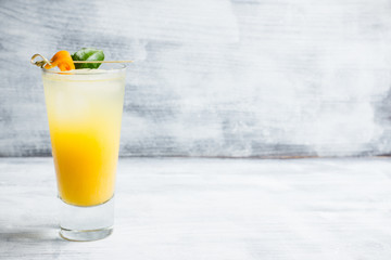 Fresh cocktail with mandarines on the rustic background. Selective focus. Shallow depth of field.