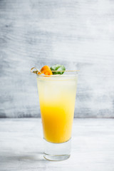 Fresh cocktail with mandarines on the rustic background. Selective focus. Shallow depth of field.