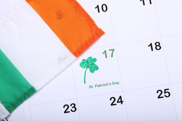 St. Patrick's Day marked on a calendar next to a flag of Ireland