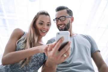 close up. a couple of students are watching a video on their smartphone