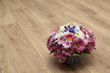 beautiful spring bouquet of wild flowers in a box on a wooden background