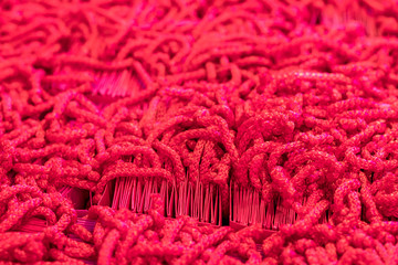 Many red-colored thread ropes.