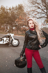 Naklejka na ściany i meble Beautiful biker woman posing outdoor. 