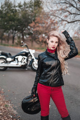 Fototapeta na wymiar Beautiful biker woman posing outdoor. 