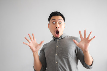 Wow and surprised face of funny good looking man with hand sign pointing.