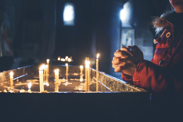 woman hand with candles in church