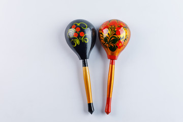 Two spoons with a traditional pattern. Wooden spoons with floral ornament in traditional folk Russian Khokhloma style on a wooden background.