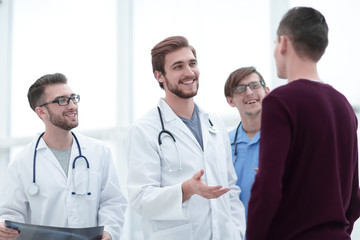 Fototapeta premium handsome doctor talking with the patient