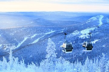Winter mountains panorama with ski slopes and ski lifts. Winter background. Skiing, winter fun.
