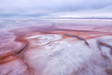 Colorful sediment in shallow saltwater in Great Salt Lake, Utah