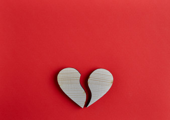 Fototapeta premium Wooden heart shape on red paper