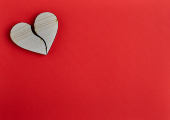 Wooden heart shape on red paper