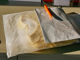 A parcel / mail on a counter in a private postal service needed to be put in an envelop and...