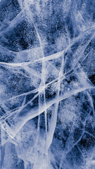 The frozen lake surface, showing a variety of textures. Blue background of Ice texture. 
