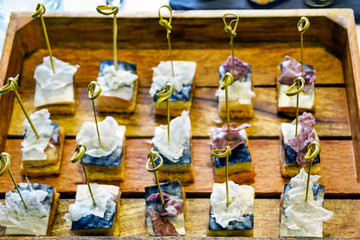 Catering Services Supply: Knots of Natural Bamboo Skewers in Mackerel Fish Canapes Placed in a Tray of Wooden Planks Served at a Business Event, Hotel, Birthday or Wedding Celebration