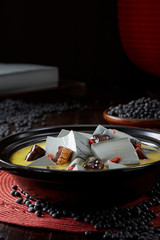 Delicious Chinese cuisine, soup with sea cucumber and black tofu in clay pot