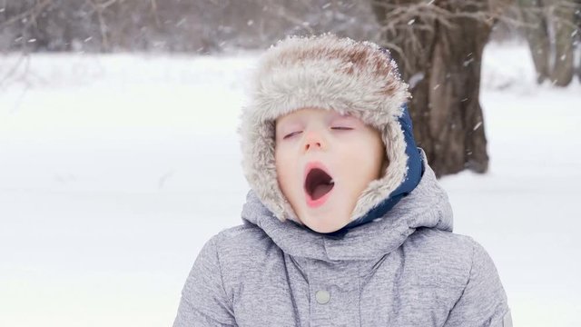 Cute little boy kid playing with toy truck and snow in winter. two years old child