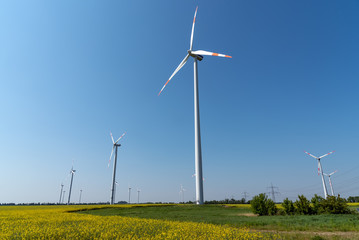Wind energy plants in front of a clear blue sky seen in Germany