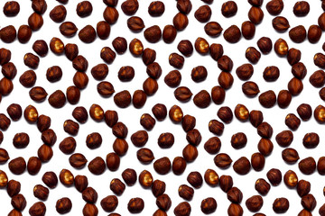 A collection of hazelnut nuts lie in the shape of a circle or sun on an isolated white background with a clipping path. Hazelnut pattern