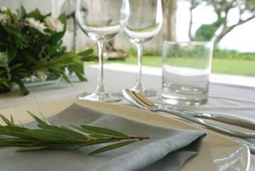 Dining set on the white table sheet with white bouquet flower background