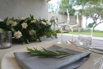  Dining set on the white table sheet with white bouquet flower background
