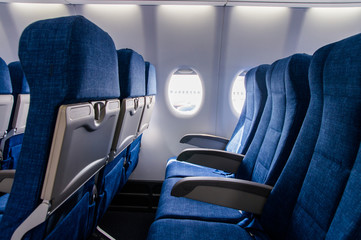 Obraz premium Interior view of economy coach seats inside of passenger airplane