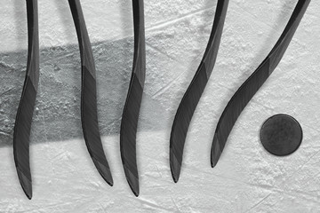 Five hockey sticks, puck and black stripe