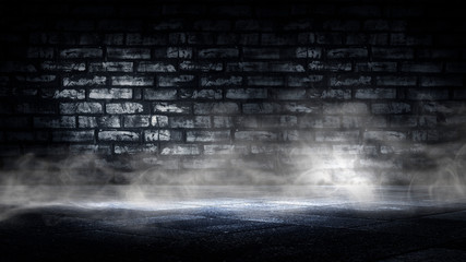 Empty dark room illuminated by a spotlight, smoke on the concrete floor. Old brick wall, studio for photography.