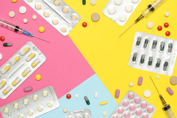 Bright background with copy space in the middle formed with different medication and pillows	