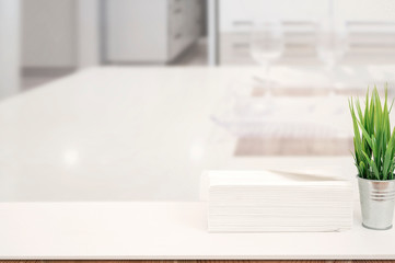 Mockup stack of paper towels on white table indoors with copy space