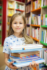  girl with books   in library.