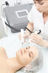 Obraz na płótnie Canvas Facial micro current cosmetology procedure. Beauty technology treatment. Woman face therapy