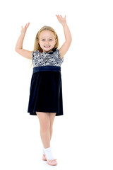 Little girl in a dress developing in the wind.