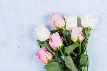 Bouquet of pink and white roses on blue concrete table backround. Top view, copy space. Valentines Day, Mother Day Holiday Concept