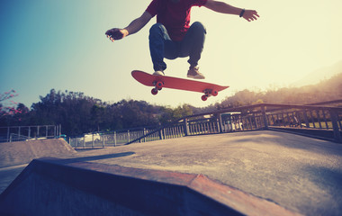 Skateboarder skateboarding at skatepark ramp