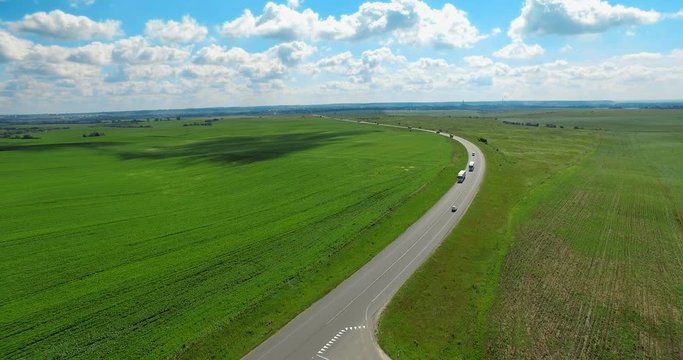 The route is in the middle of two green fields, Ukraine, Rivne, Aerial drone view