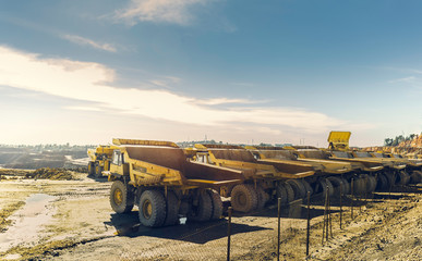 Large dumper trucks in the open pit mine of Riotinto, lined up waiting for their next assignment © Juanrastock