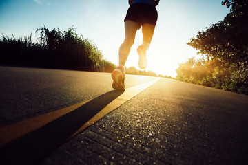 Fitness woman running on seaside trail in the morning - obrazy, fototapety, plakaty