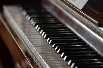 Antique piano keys and wood grain. Closeup, selective focus